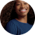 A young black woman with curly hair smiling in a circle.